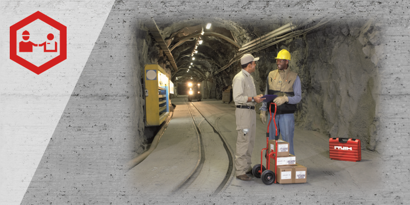 Two men speaking in a tunnel